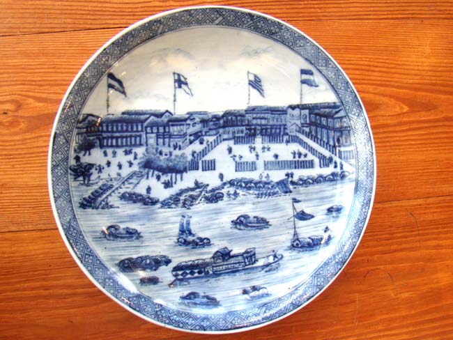 A fine late 19th or early 20th century Chinese plate depicting the 'Hongs of Canton' circa 1830
